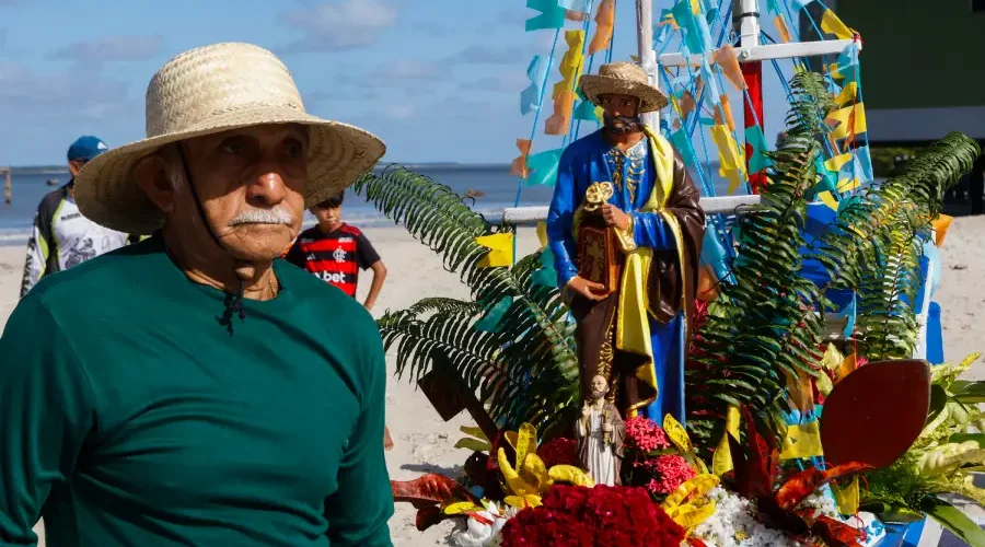 Pescadores locais acompanham a imagem de São Pedro adornada com fitas e flores coloridas na praia de Algodoal. A procissão de barcos é uma tradição de longa data na Ilha de Maiandeua. Foto: Oswaldo Forte.